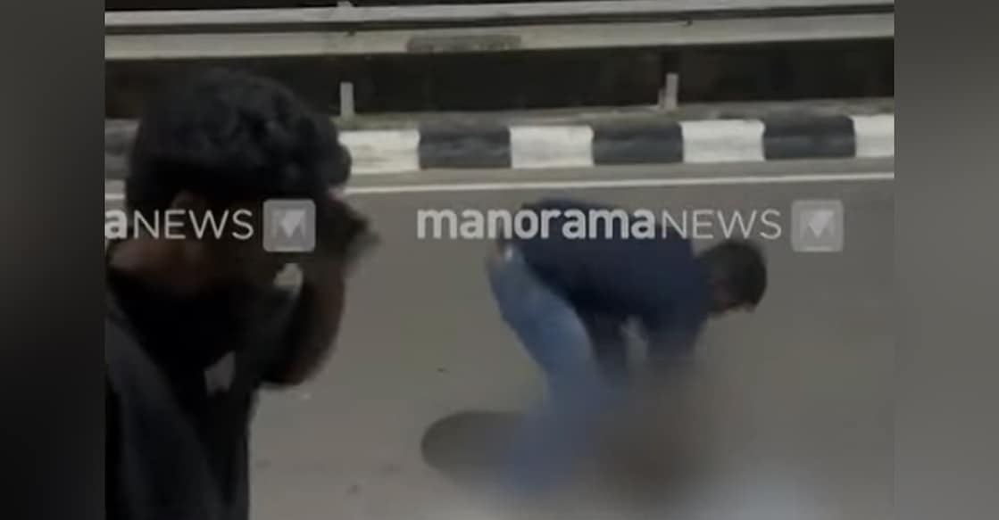 A screengrab showing two of the accused beating Suman while he was lying on the road. Photo: Manorama News