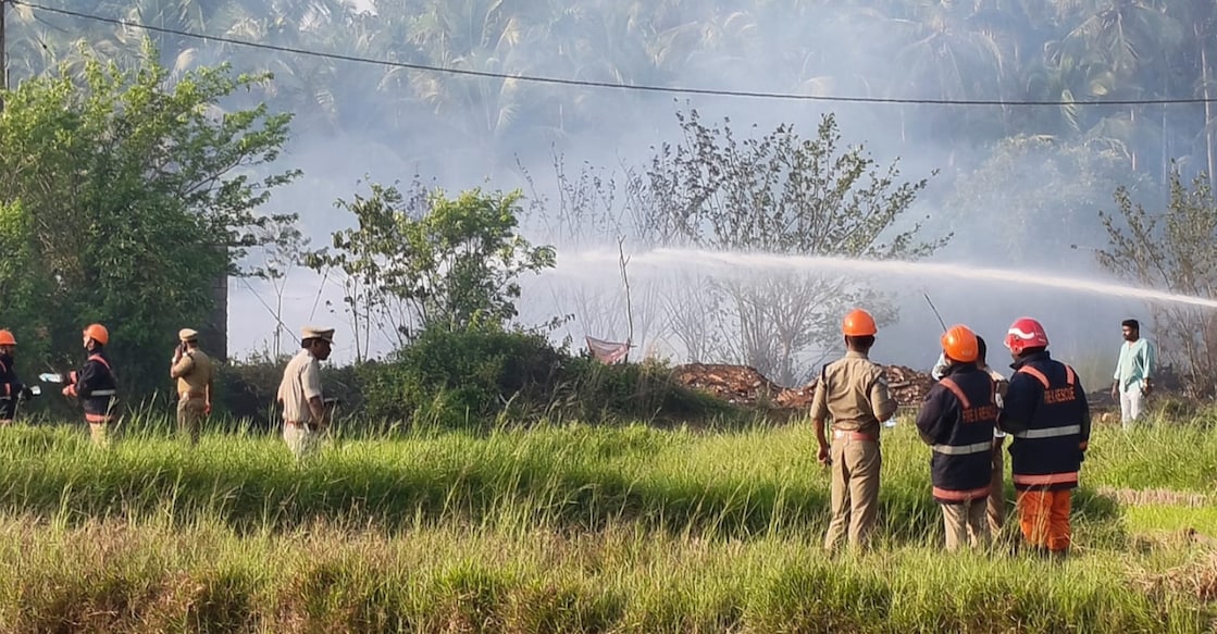 Rescue officials work to douse the fire at the site. Photo: Special Arrangement. 
