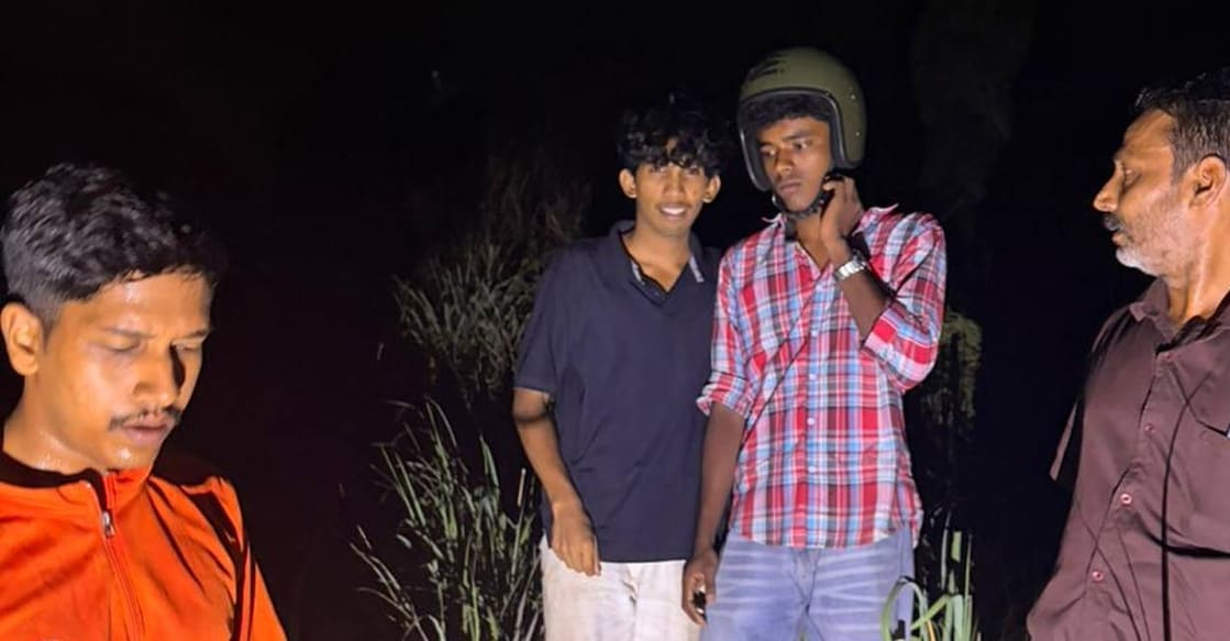 Adidev and Kamal with the rescuers. Photo: Special Arrangement. 