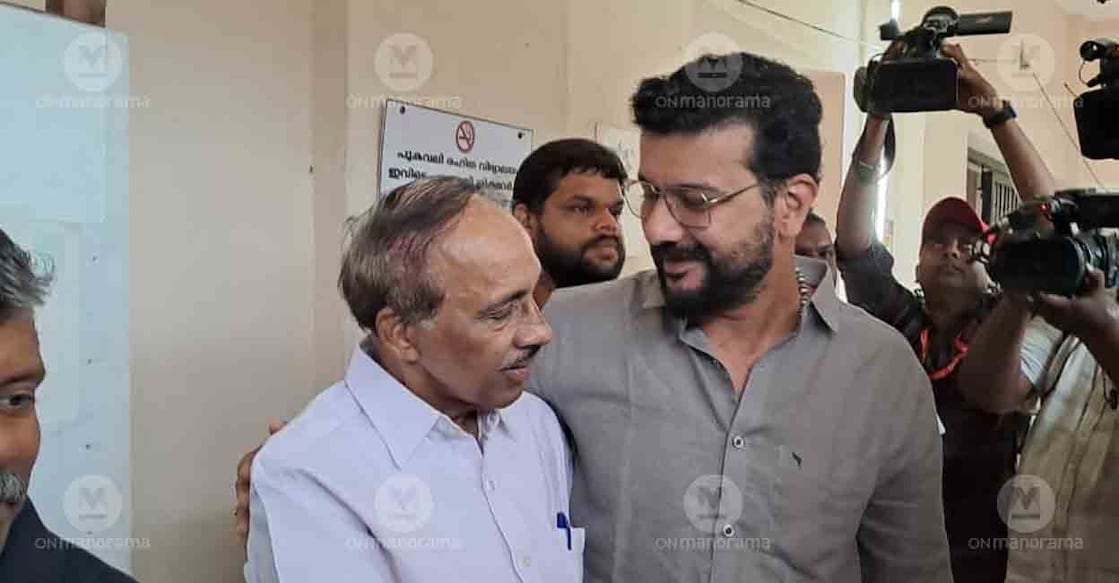 Ramesh Pisharody greets K Babu at the polling booth. Photo: Onmanorama