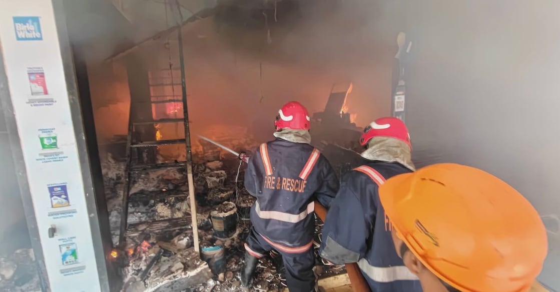 Fire officials attempt to bring the blaze at the Indian Associates paint shop under control. Photo: Special Arrangement