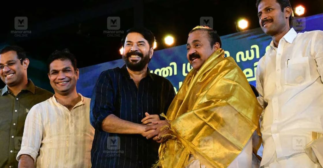 Mammootty honouring the Chief Minister by presenting him with a traditional ponnada. Photo: Manorama