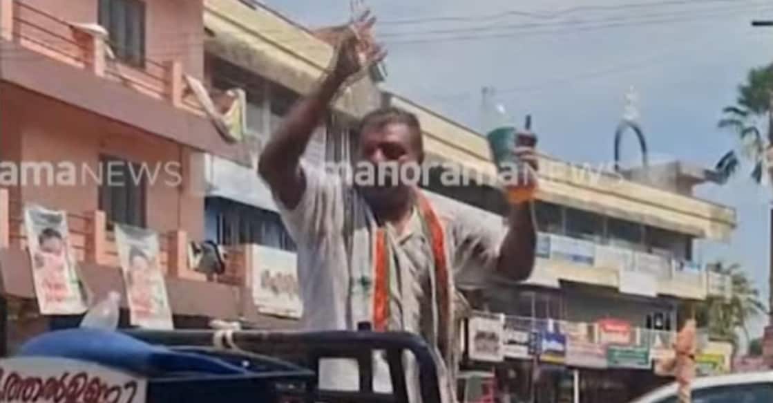 A screengrab showing Francis holding a bottle of petrol, threatening to immolate himself. Photo: Manorama News