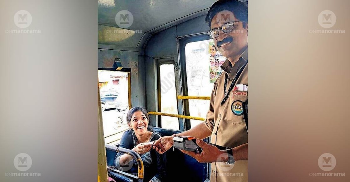 KSRTC conductor S Murukan hands over a free-travel ticket to his daughter M T Sreenidhi aboard a bus at the Pappanamcode depot on the inaugural day of the Priyadarshini scheme. Photo: Special arrangement