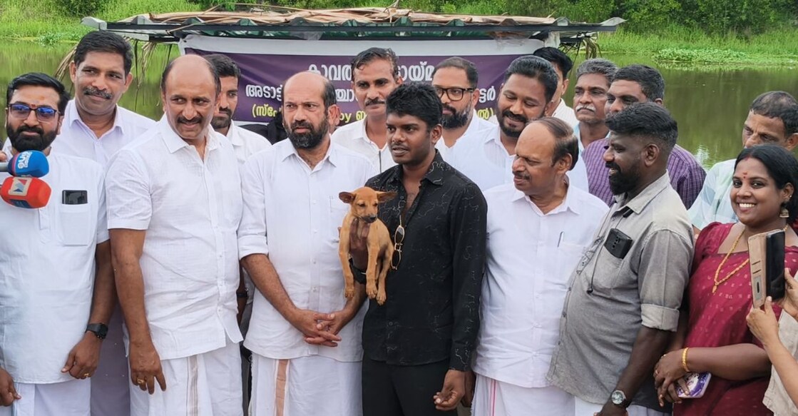 Rapper Vedan with the adopted puppy posing for a picture alongside former MLA Anil Akkara (standing left to Vedan). Photo: Special arrangement