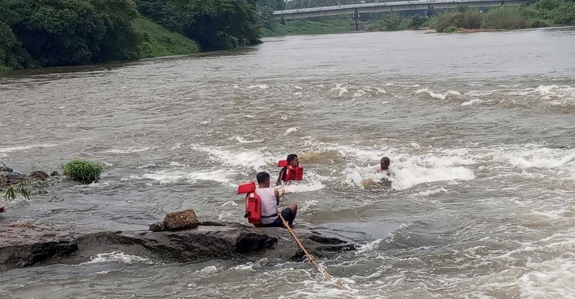 Fire and rescue personnel rescue a man from the Koodappuzha check dam. Photo: Special arrangement
