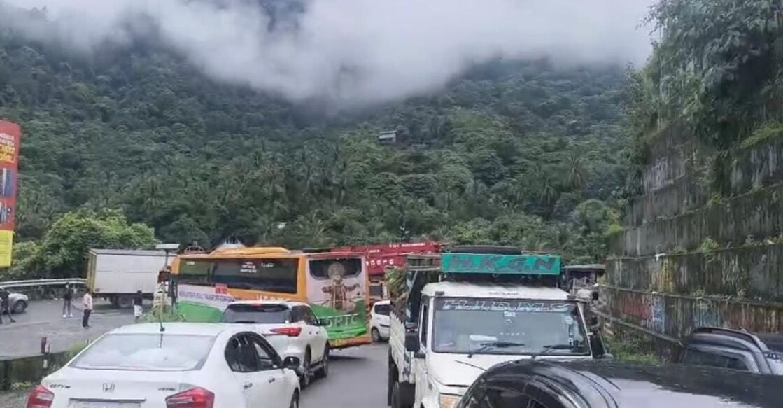 Vehicles remain stranded at a mountain pass as traffic comes to a near standstill following heavy congestion.