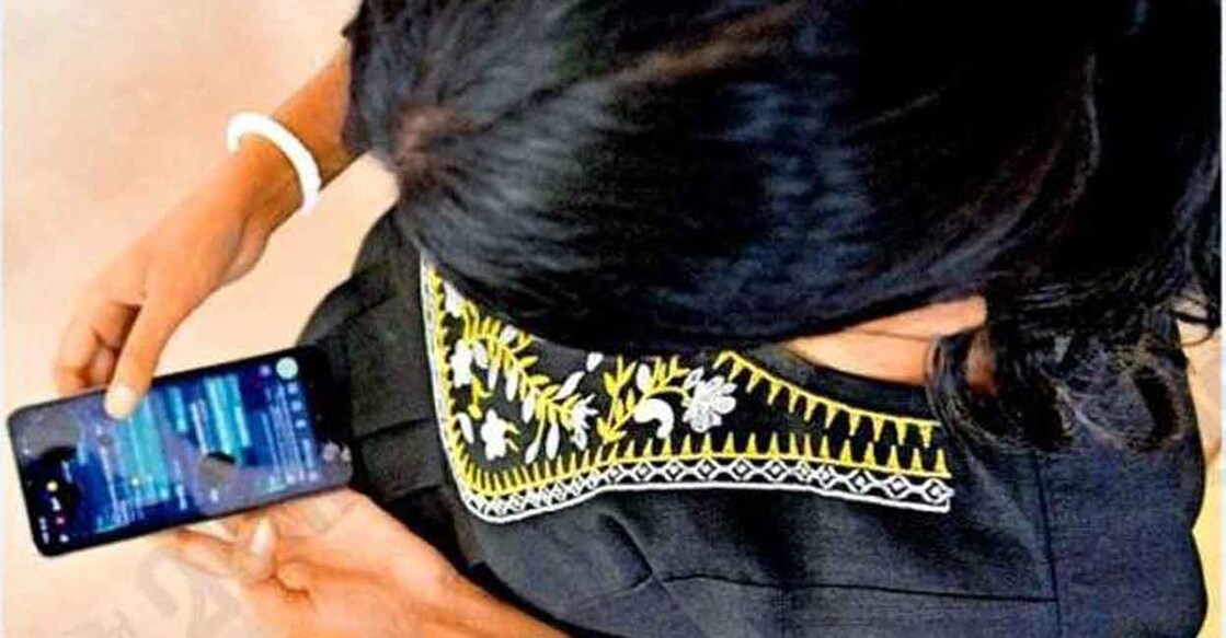 Assamese woman, who allegedly escaped the clutches of a baby trafficking racket, shows the messages on her phone. Photo: Manorama