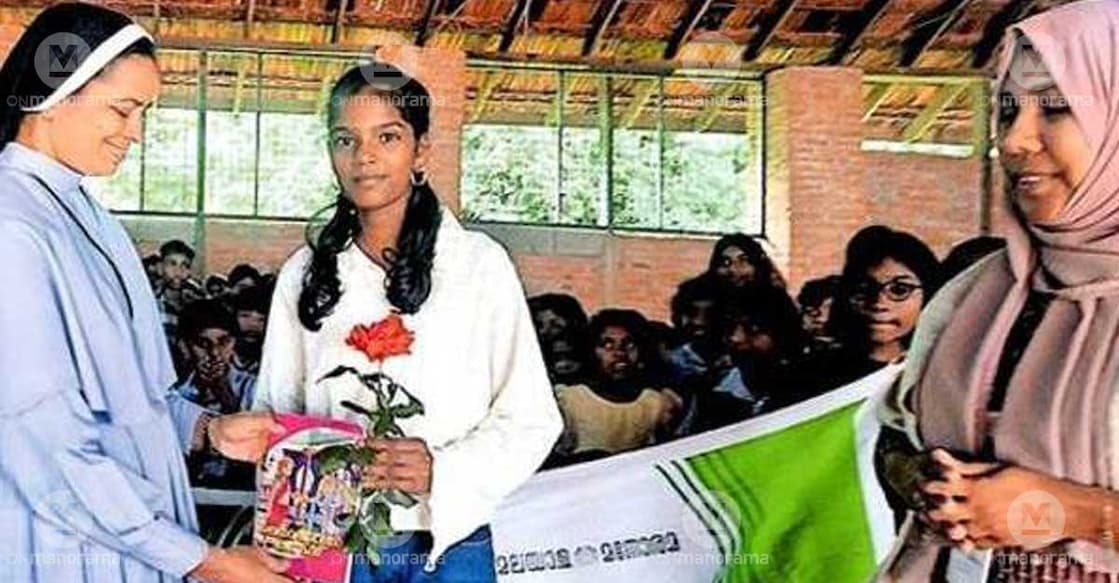 A S Adya, a Class VI student of St Joseph's UP School, Narakakkanam, presents a book to Headmistress Sister Shiny Joseph to mark the launch of the school's new reading initiative. Photo: Special arrangement