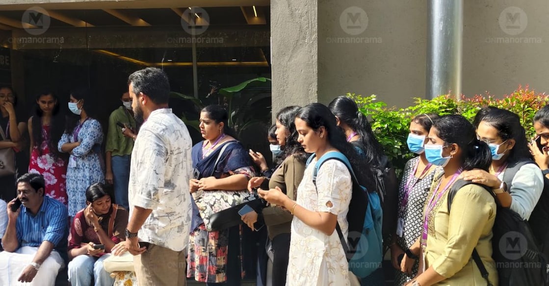 Sacked employees of CorroHealth protest outside its office in Kochi after they were denied entry on Monday morning. Photo: Manorama.
