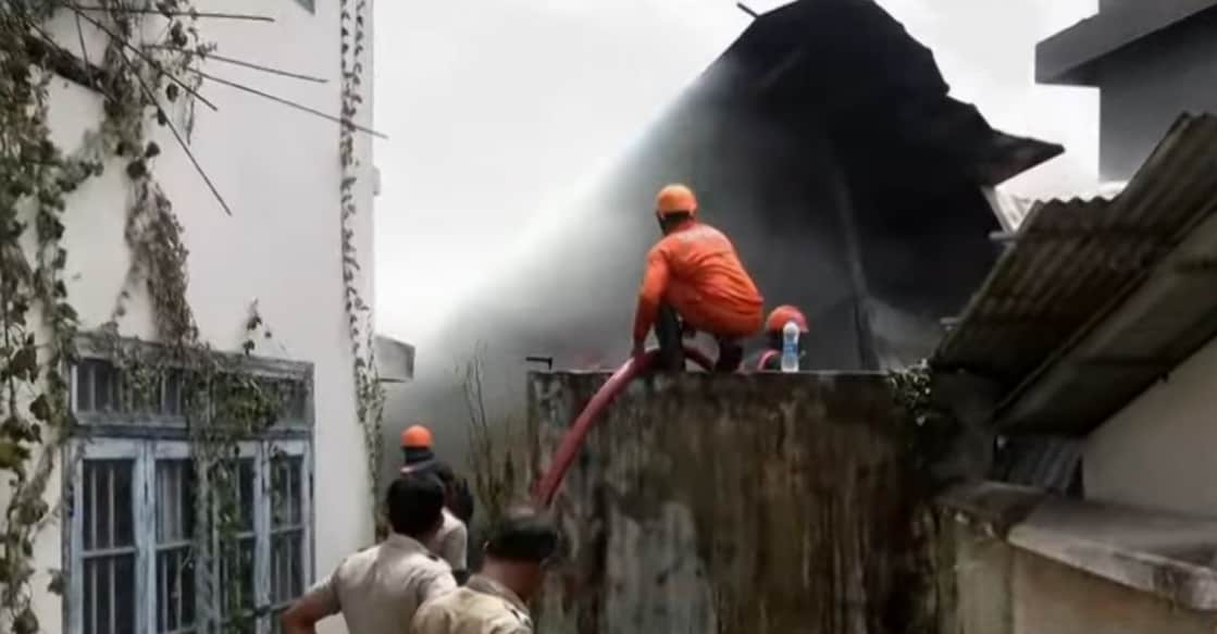 Officials working to douse the fire that broke out at a furniture shop in Plamoodu. Photo: Screengrab/ Manorama News