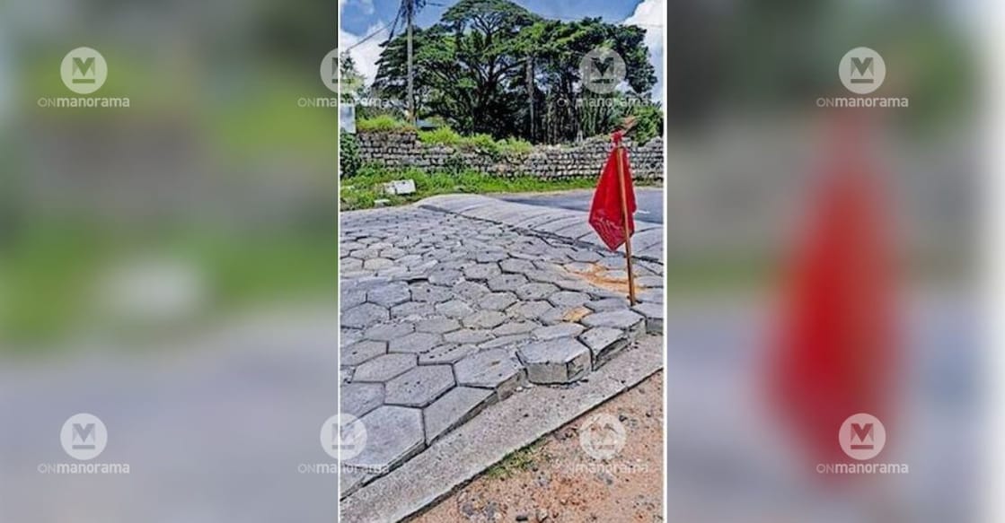  A red flag placed to alert motorists to the sunken interlock stretch at the Oottara railway level crossing in Kollengode. Photo: Special Arrangement.