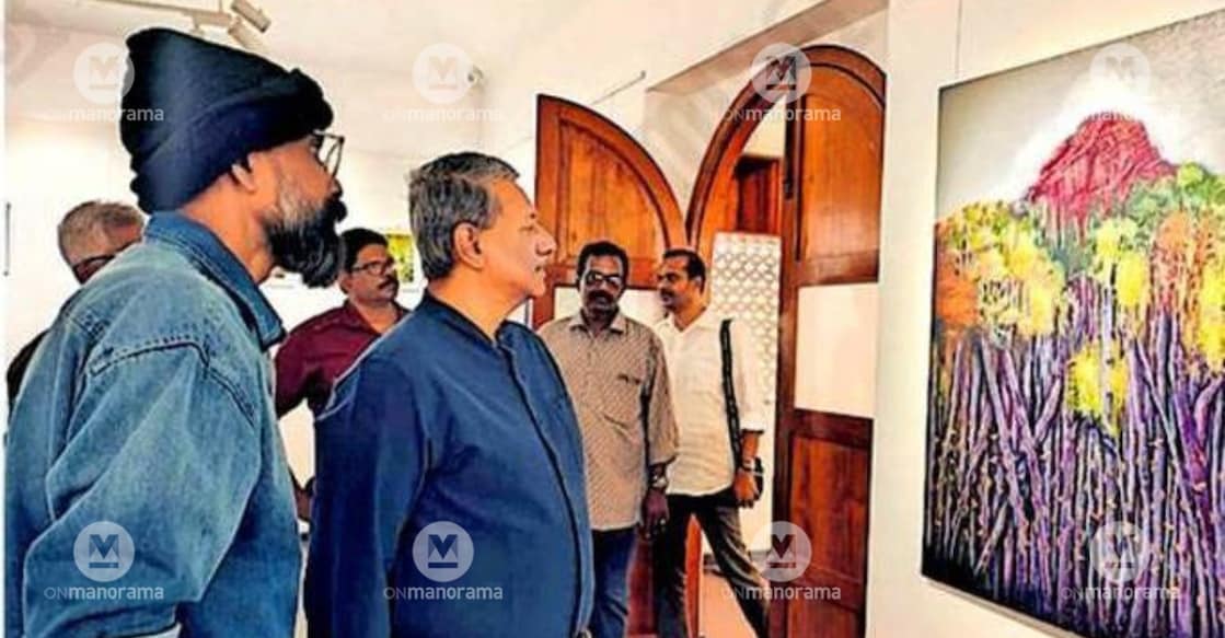 Public Library honorary secretary Prathap R Nair views the works of Binu Kottarakkara at the ‘Kaadu’ exhibition at the Quilon Art Gallery. Artist Binu Kottarakkara is seen nearby. Photo: Special Arrangement.