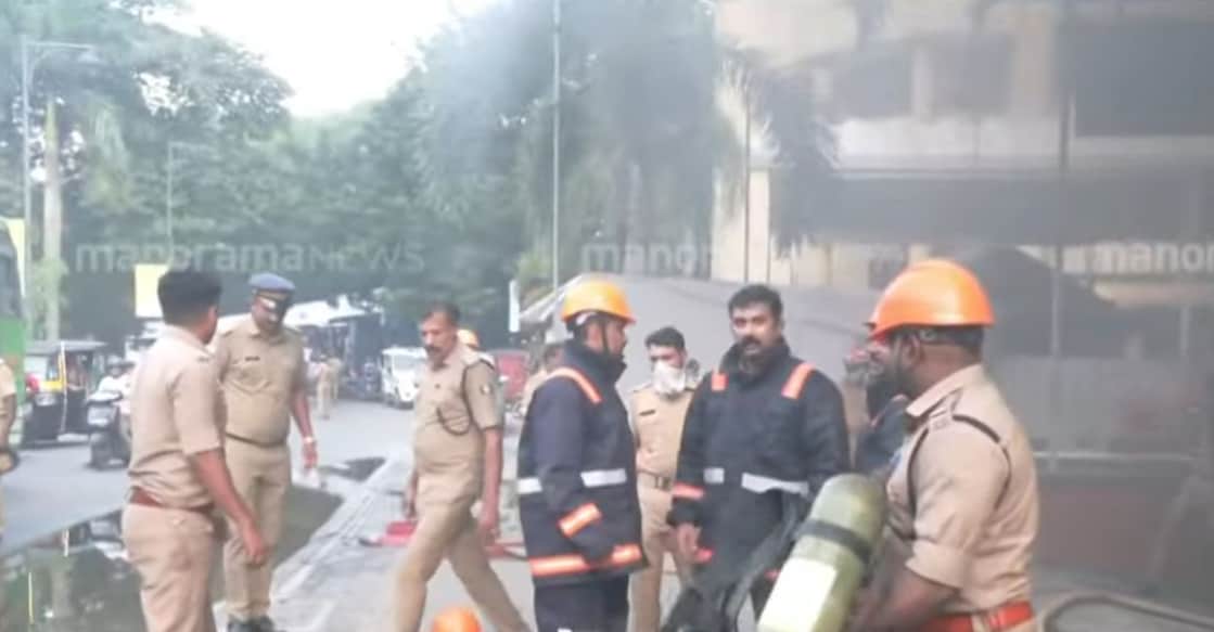 Fire and Rescue officials working to contain the fire that broke out at the Samudra Darshan Apartments in Marine Drive. Photo: Screengrab/ Manorama News