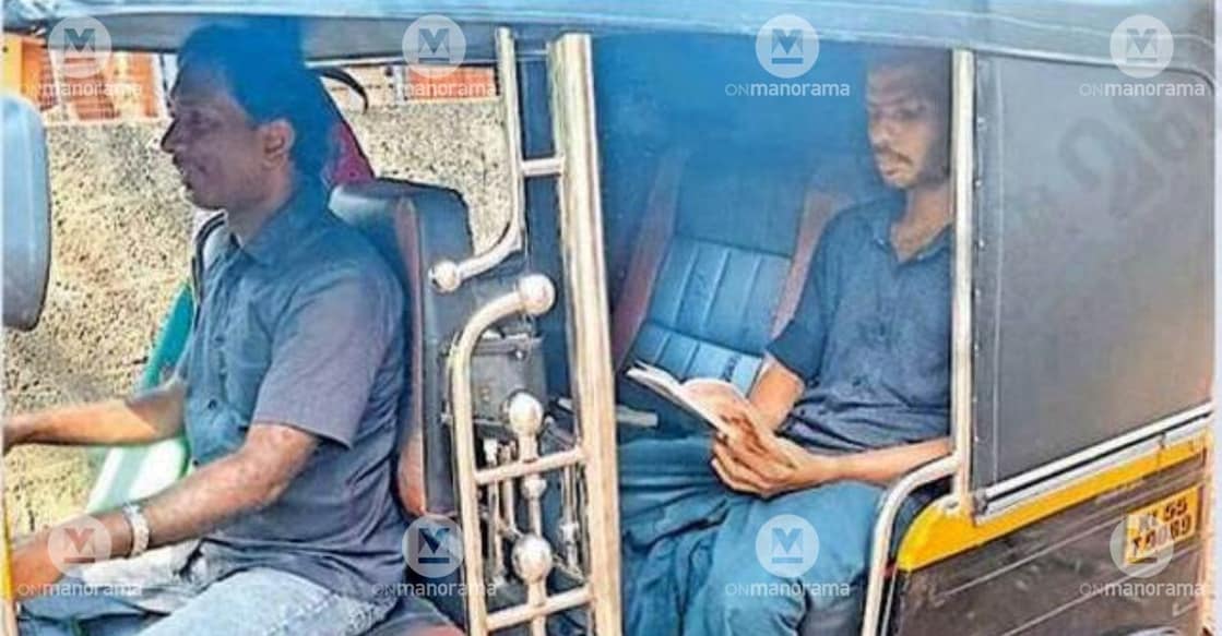 A passenger reading a book while riding an auto-rickshaw in Kottur, Kottakkal. Photo: Special Arrangement.