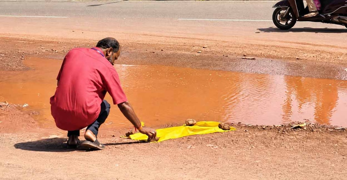 Kumbla Panchayat member K Ajith Kumar covers carcass of snake before cremation. Photo: Special arrangement