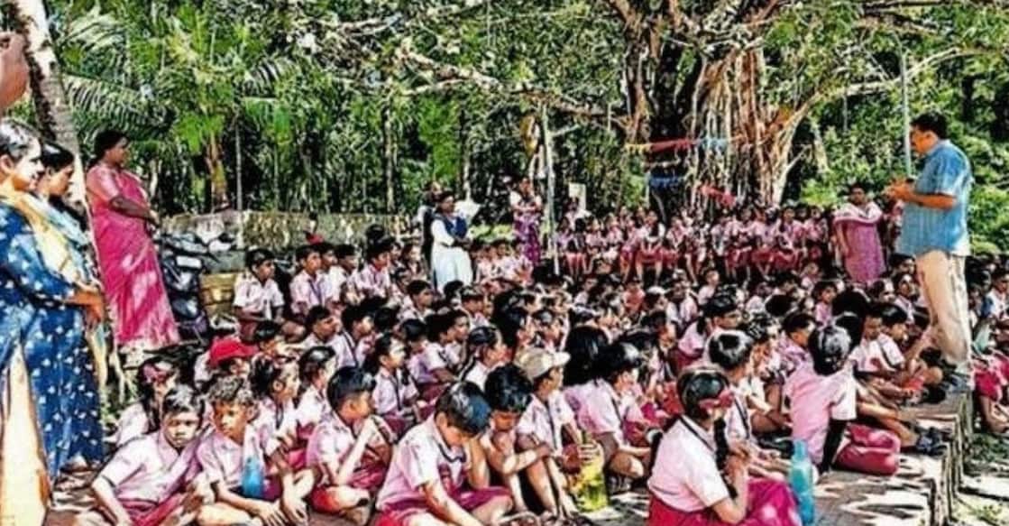 Students from Anthikkad KGM Lower Primary School, accompanied by Headmaster Joshi D. Kollannoor, visited the sacred grove located on the property of MLA K. Rajan's ancestral home in Anthikkad. The MLA's mother, Ramani, welcomed the students at the grove. Photo: Special Arrangement.