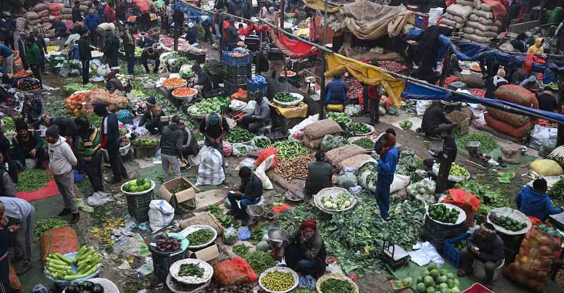 People buy vegetables at a market in the old quarters of Delhi on December 30, 2025. File Photo: AFP/Arun Sankar