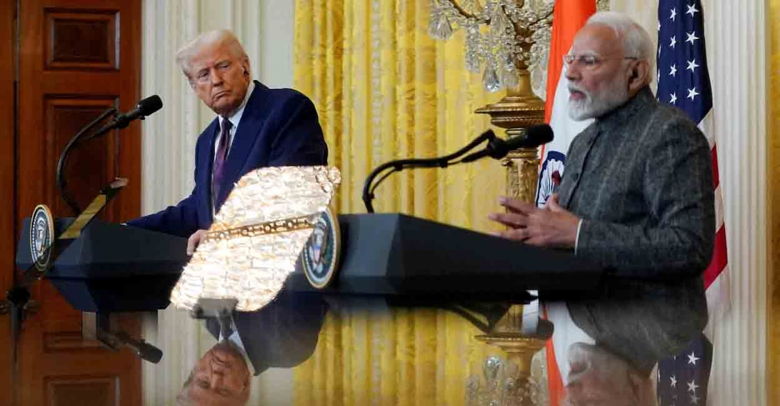 FILE PHOTO: U.S. President Donald Trump and Indian Prime Minister Narendra Modi are pictured in a mirror as they attend a joint press conference at the White House in Washington, D.C., U.S., February 13, 2025. REUTERS/Nathan Howard/File Photo