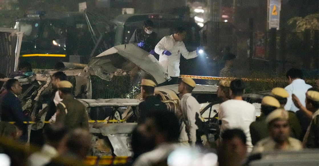 Police and forensic officials at the scene of the blast. Photo: PTI