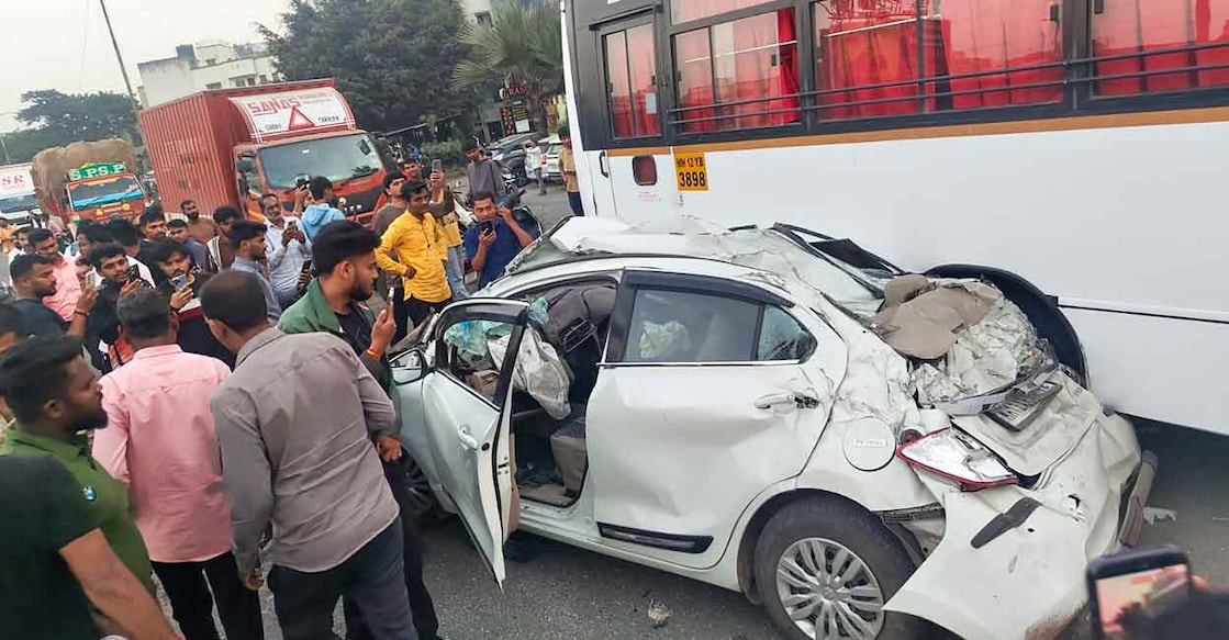 People stand near mangled remains of a car after an accident on the Mumbai-Bengaluru Highway, in Pune, Maharashtra, Thursday, Nov. 13, 2025. Photo: PTI