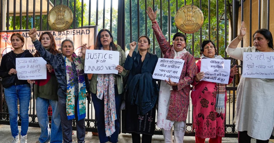 Agitators, including women activists, hold placards as they stage a protest against the suspension of the jail term of Kuldeep Sengar, a former BJP MLA who was convicted in the Unnao rape case, outside the Delhi High Court, in New Delhi. Photo: PTI