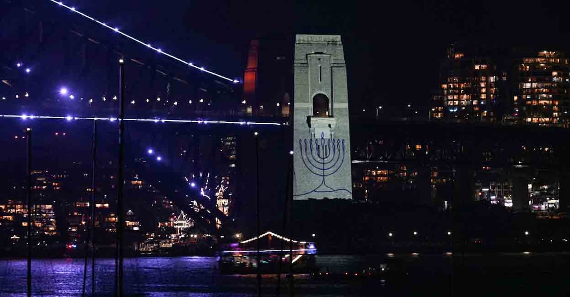 The figure of a menorah is displayed on the pylon of the Sydney Harbour Bridge to reflect on the tragic Bondi Beach shooting attack before New Year's Eve midnight fireworks display in Sydney on December 31, 2025. Photo: AFP/ Saeed Khan