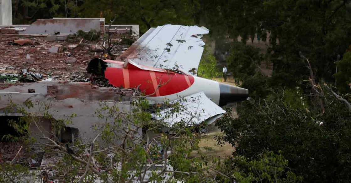 A tail of an Air India Boeing 787 Dreamliner plane that crashed is seen stuck on a building after the incident in Ahmedabad, India, June 12, 2025. Photo: REUTERS/Amit Dave
