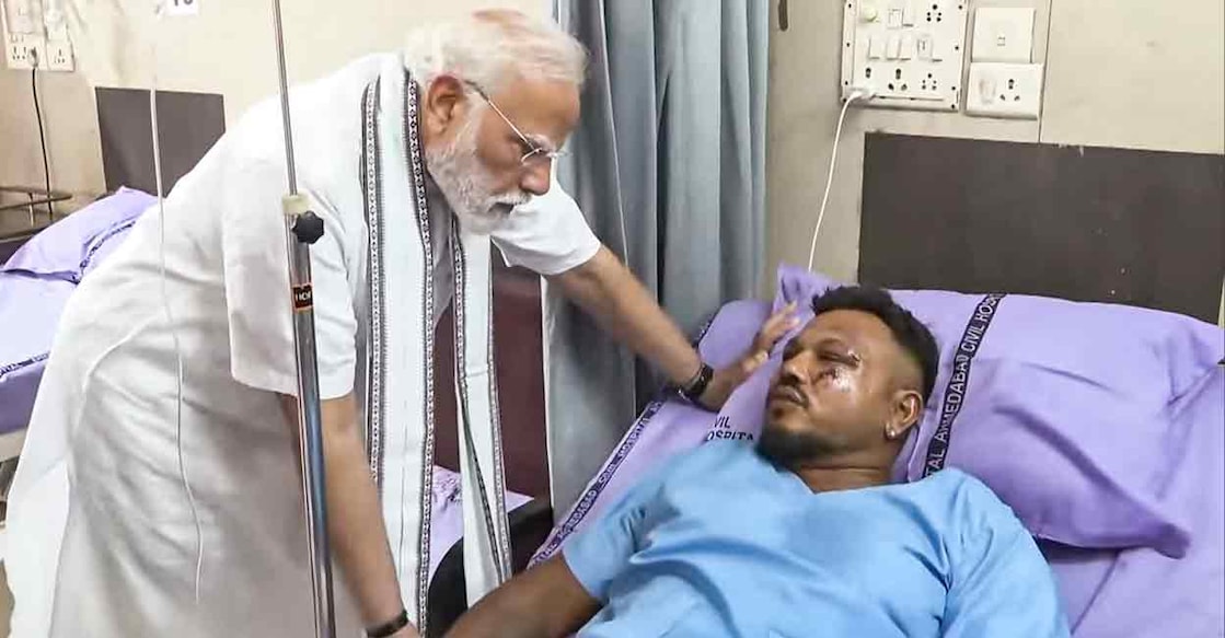 PTI06_13_2025_000056B Prime Minister Narendra Modi meets Vishwash Kumar Ramesh, the lone survivor of yesterday's Air India plane crash, at a hospital, in Ahmedabad, Friday, June 13, 2025. A London-bound Air India plane carrying 242 passengers crashed moments after taking off from the Ahmedabad airport on Thursday. Photo: PMO via PTI Photo