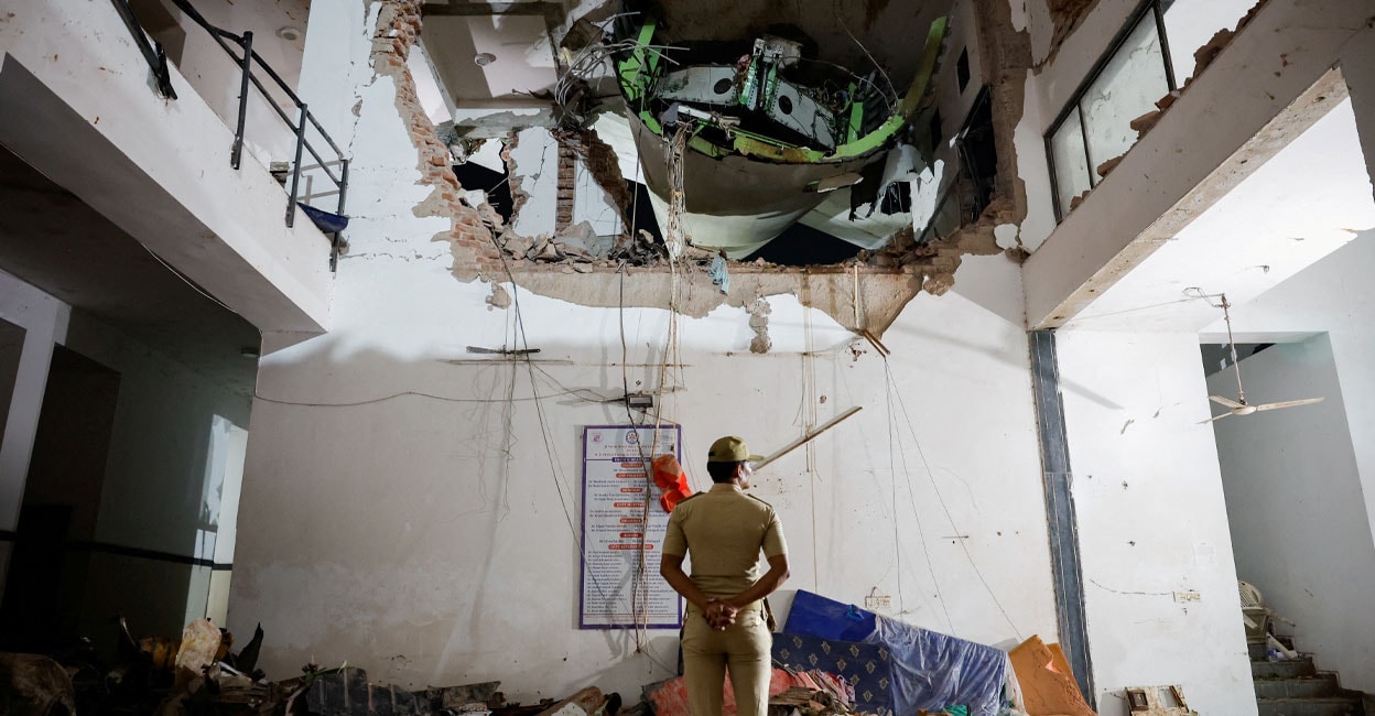 ahmedabad-plane-crash A police officer stands in front of the wreckage of the Air India aircraft: REUTERS/Adnan Abidi/File Photo