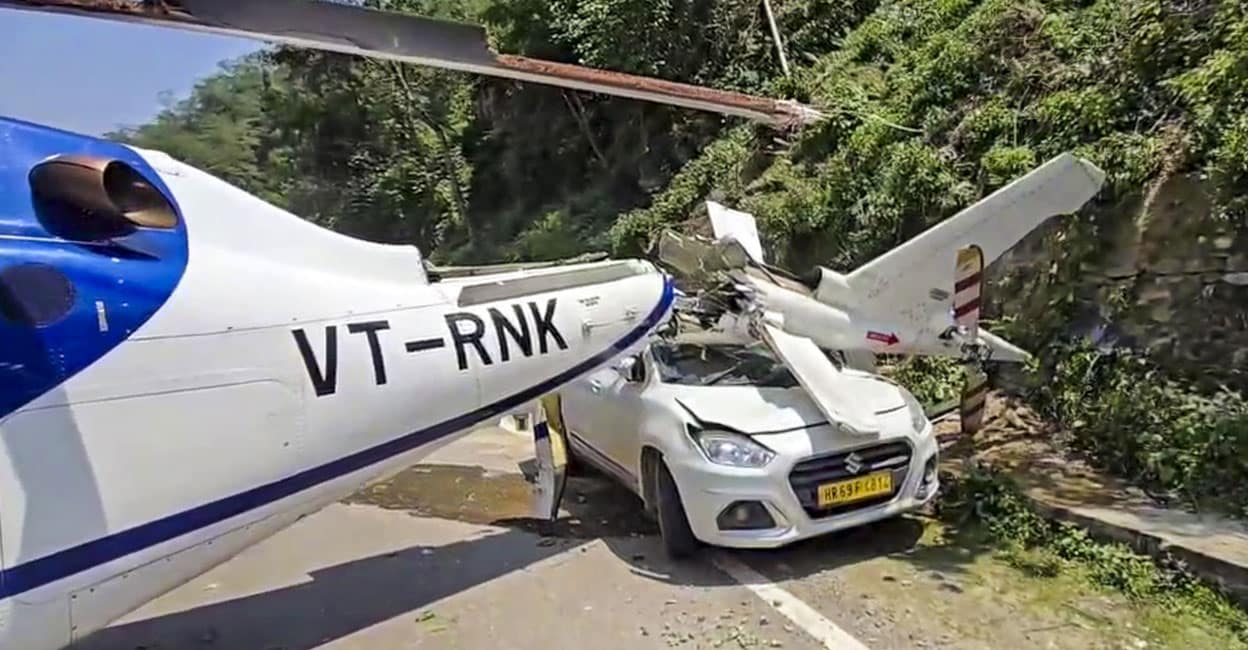 helicopter-emergency-landing The damaged tail boom of a Kedarnath Dham-bound helicopter lies atop a car after it made an emergency landing at Badasu. Photo: PTI
