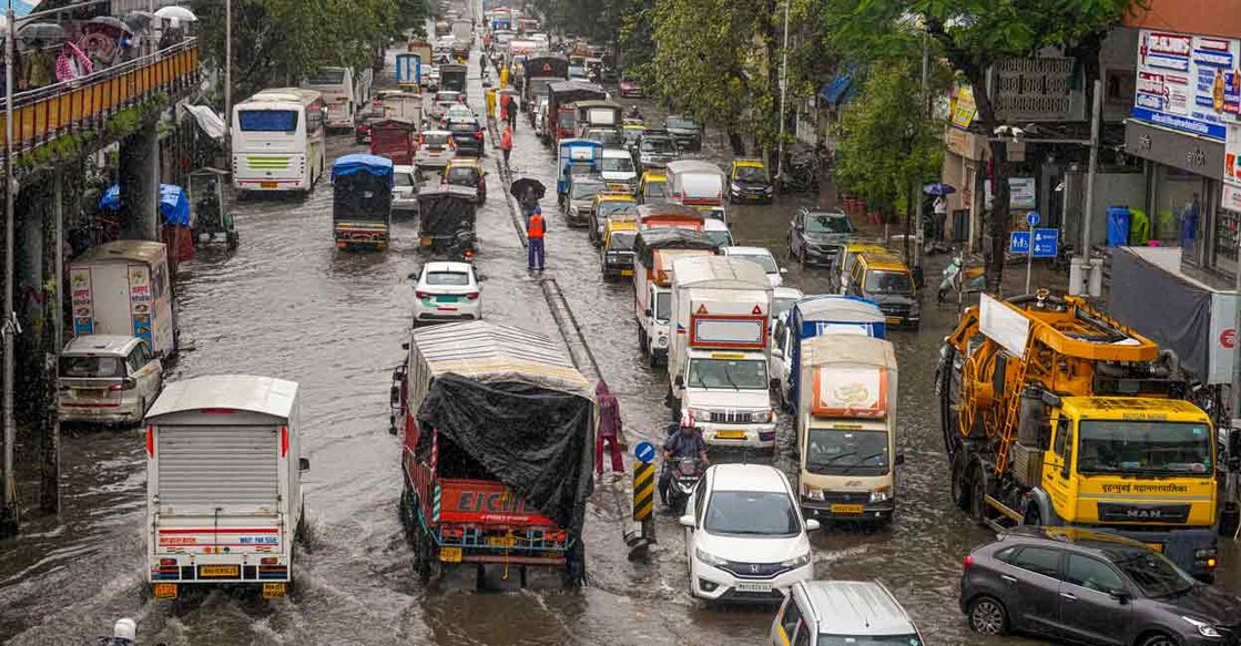 Commuters wade through a waterlogged road following heavy rainfall, at Kurla in Mumbai, Monday, Aug. 18, 2025. Photo: PTI/Kunal Patil