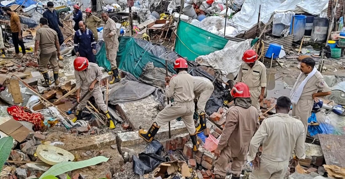 Rescue work underway after a wall collapsed amid heavy rains near Mohan Baba Mandir at Harinagar in Delhi's Jaitpur. Photo: PTI