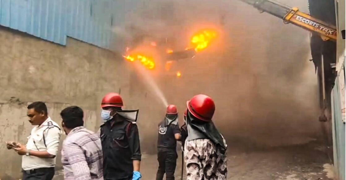 A firefighter douses a fire triggered by an explosion at a textile processing unit, in Surat district of Gujarat. Photo: PTI