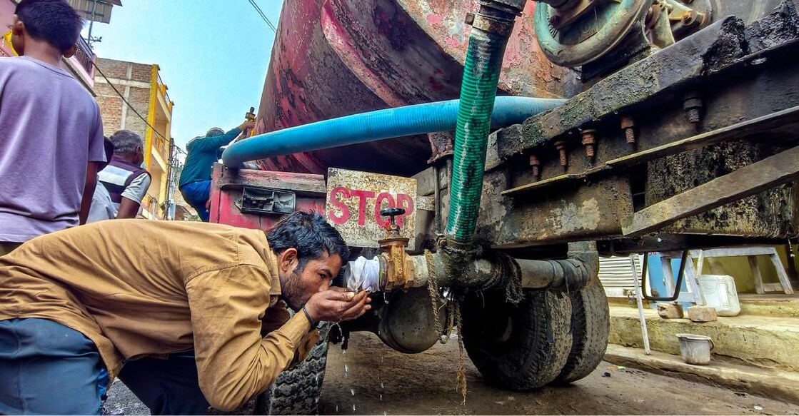 A man drinks water from a tanker amid a contaminated water crisis at Bhagirathpura, in Indore. Photo: PTI