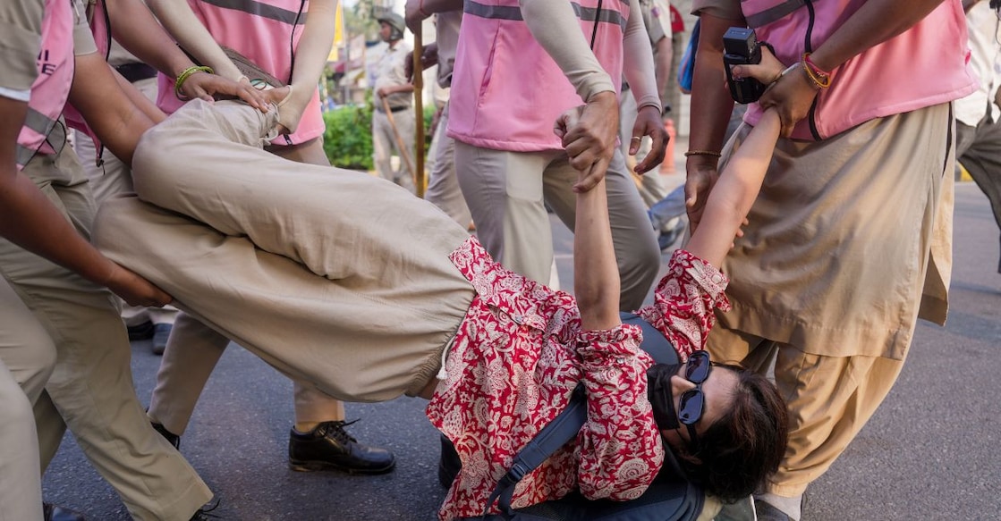 Police personnel detain a woman activist during a demonstration called by the Cockroach Janta Party (CJP) demanding the resignation of Chief Election Commissioner (CEC) Gyanesh Kumar over alleged electoral roll irregularities at Connaught Place in New Delhi on Saturday. Photo: PTI.