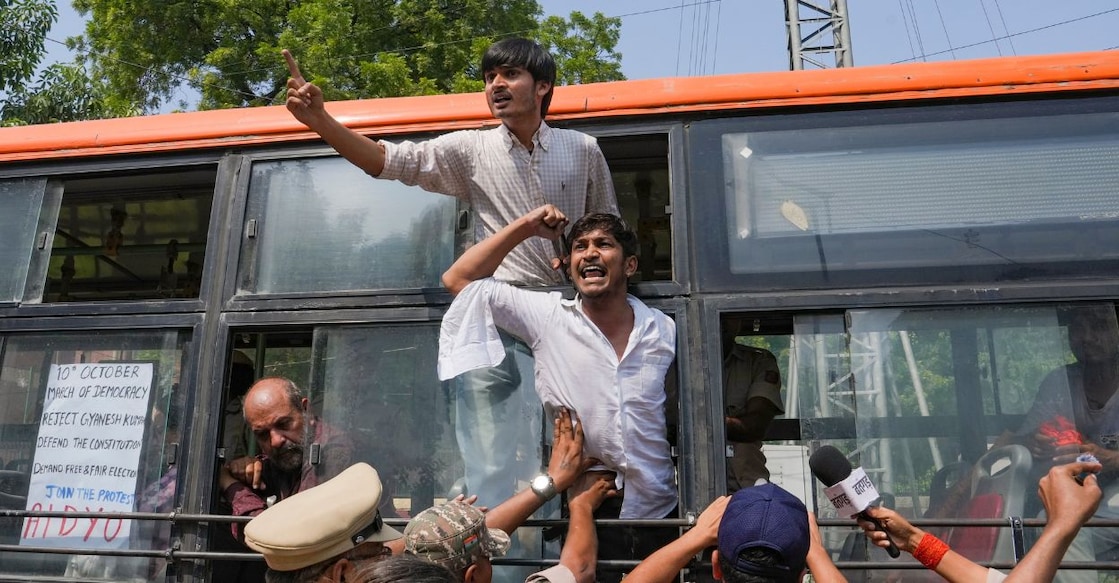 Demonstrators shout slogans from inside a police vehicle after being detained during a protest demonstration organised by the Cockroach Janta Party (CJP) demanding the resignation of Chief Election Commissioner (CEC) Gyanesh Kumar over alleged electoral roll irregularities, in New Delhi, Saturday. Photo: PTI.