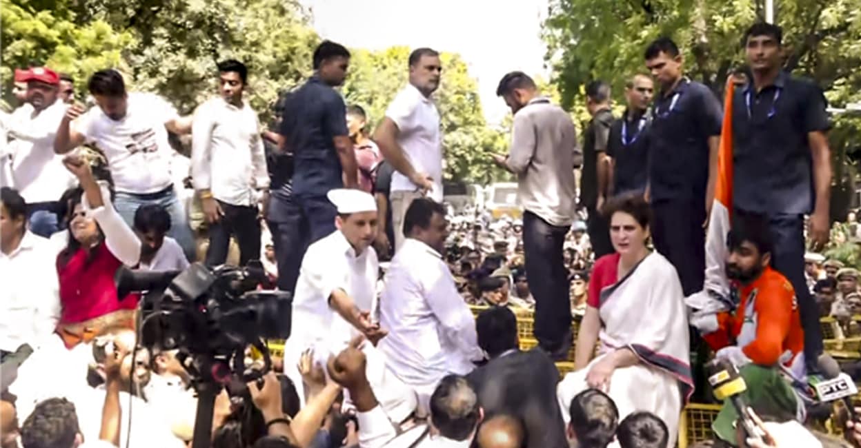 delhi-oppostn-protest Leader of Opposition in the Lok Sabha Rahul Gandhi, Congress MP Priyanka Gandhi Vadra atop police security barricades after security forces stopped their march from Parliament toward the Election Commission of India (ECI) office. Photo: PTI
