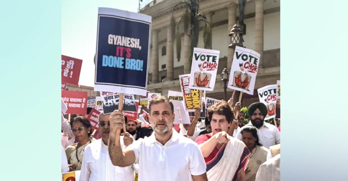 Leader of Opposition in the Lok Sabha Rahul Gandhi holds a placard reading 'Gyanesh, It's Done Bro!' alongside Congress leader Priyanka Gandhi Vadra during an INDIA bloc protest march from Parliament toward the Election Commission office. Photo: PTI