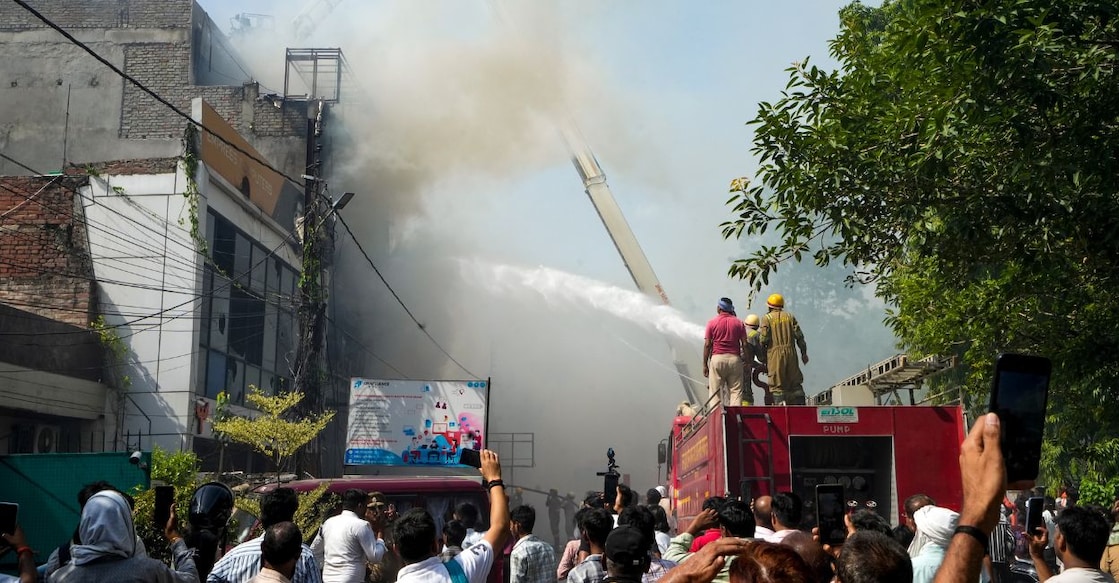 Fire personnel conduct a dousing operation after a fire broke out at a commercial building in Aliganj, Lucknow, Uttar Pradesh, on Monday. Photo: PTI