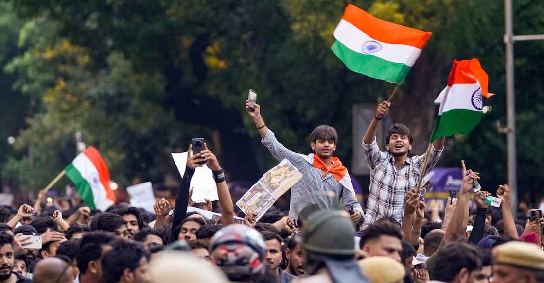 Cockroach Janta Party (CJP) supporters wave the national flag during a protest demanding the resignation of Union Education Minister Dharmendra Pradhan over NEET paper leak issue, in New Delhi, Thursday, July 23, 2026. Photo: PTI