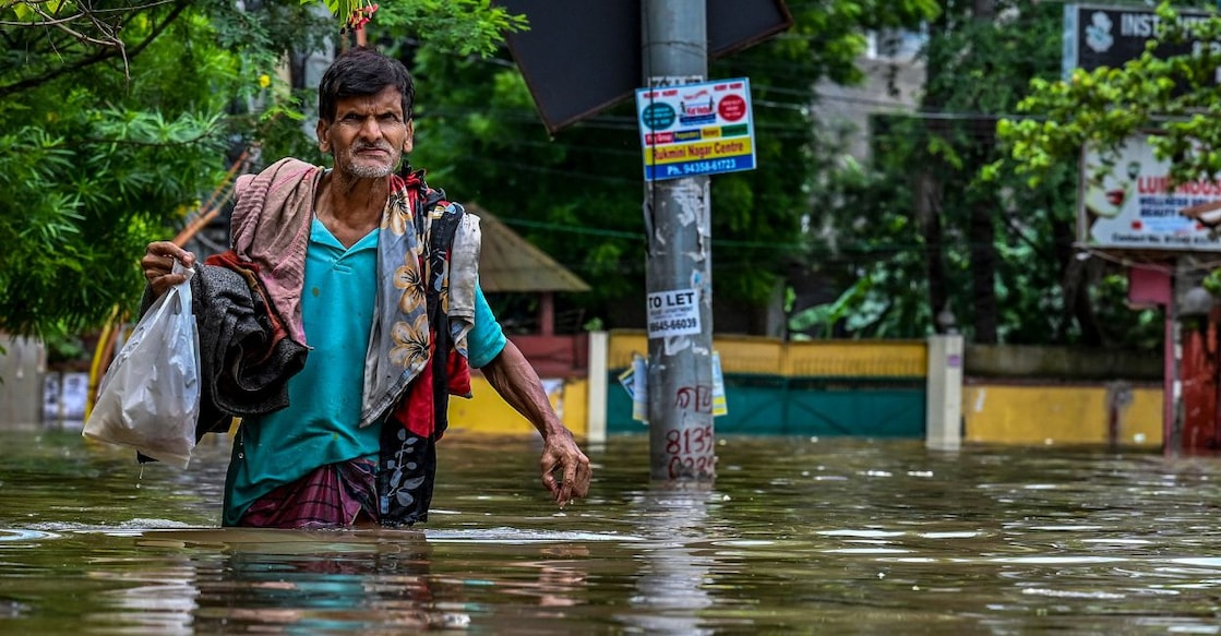 A man wades through a waterlogged road following heavy rainfall, in Guwahati, Assam in  July 2026. Photo: PTI 