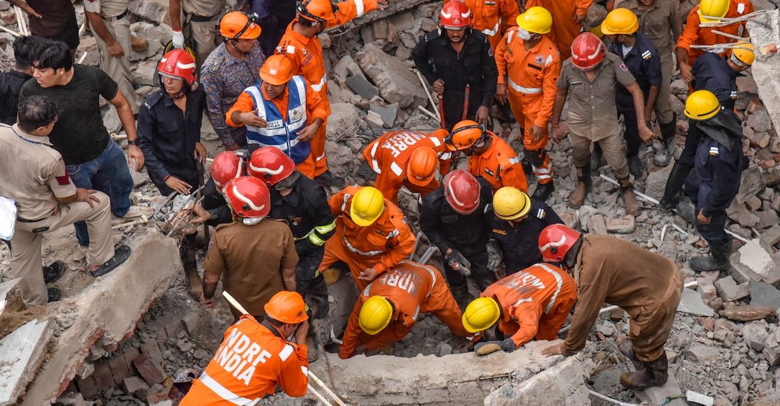NDRF and other personnel during a search and rescue operation at the site after a three-storey under-construction house collapsed at Rohini amid heavy rainfall, in New Delhi. Photo: PTI