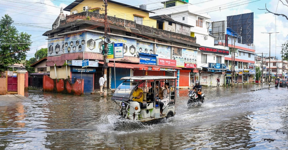 Vehicles wade through a waterlogged area following rainfall, at Hatigaon, in Guwahati, Assam on August 9, 2026. Photo: PTI