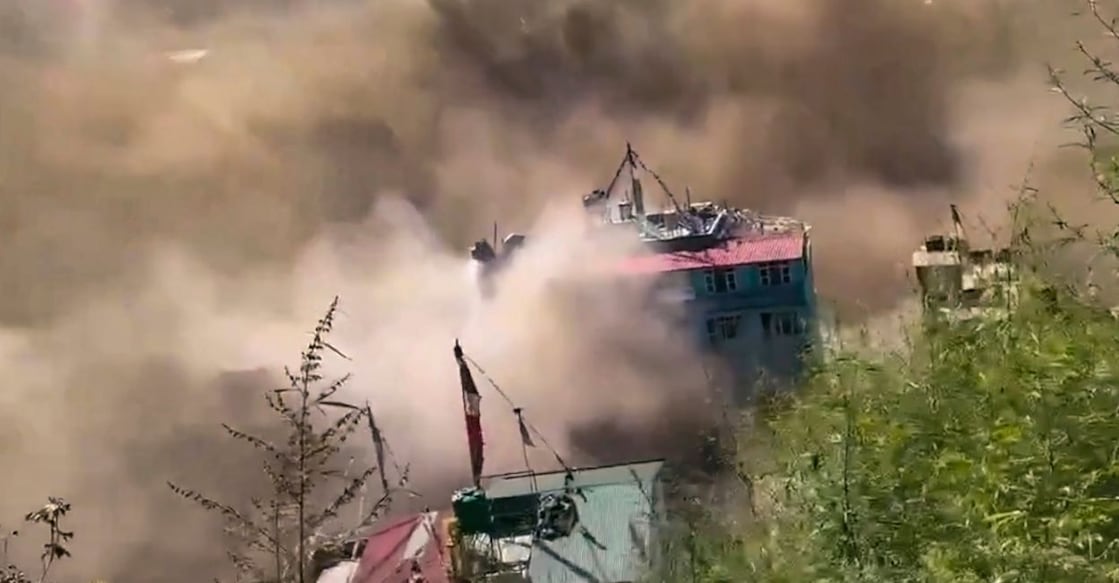 In this screengrab from a video posted on Aug 26,  a building collapses amidst dust and debris from a sudden and massive flood in Kathmandu, Nepal. Photo: PTI. 