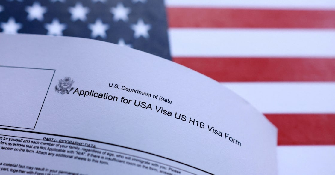 An illustration of the U.S. flag and U.S. H-1B Visa application form. Photo: Reuters 