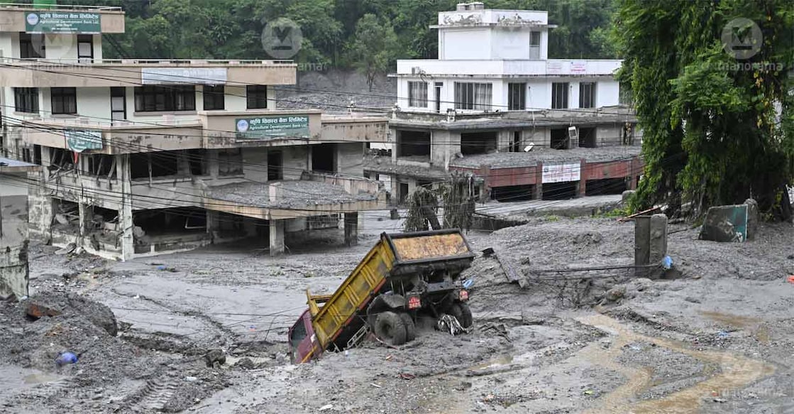 Vehicles buried in the soil due to floodwaters in Dhunge, Nuwakot district of Nepal. Photo: Josekutty Panackal/Manorama