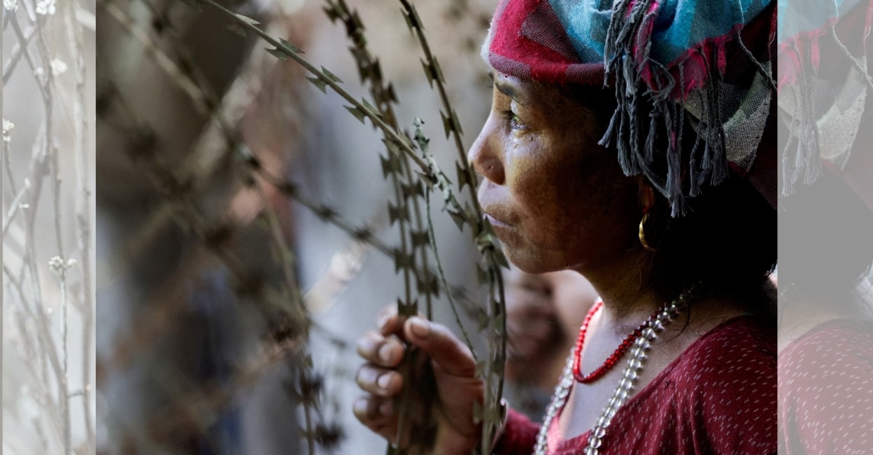 A woman looks through barbed wire as she waits for updates on the whereabouts of her missing family member outside the Maithili Barrack, an army training centre, which serves as a primary base to airlift survivors from Rasuwa at Trishuli in Nuwakot district, Nepal. Photo: Reuters
