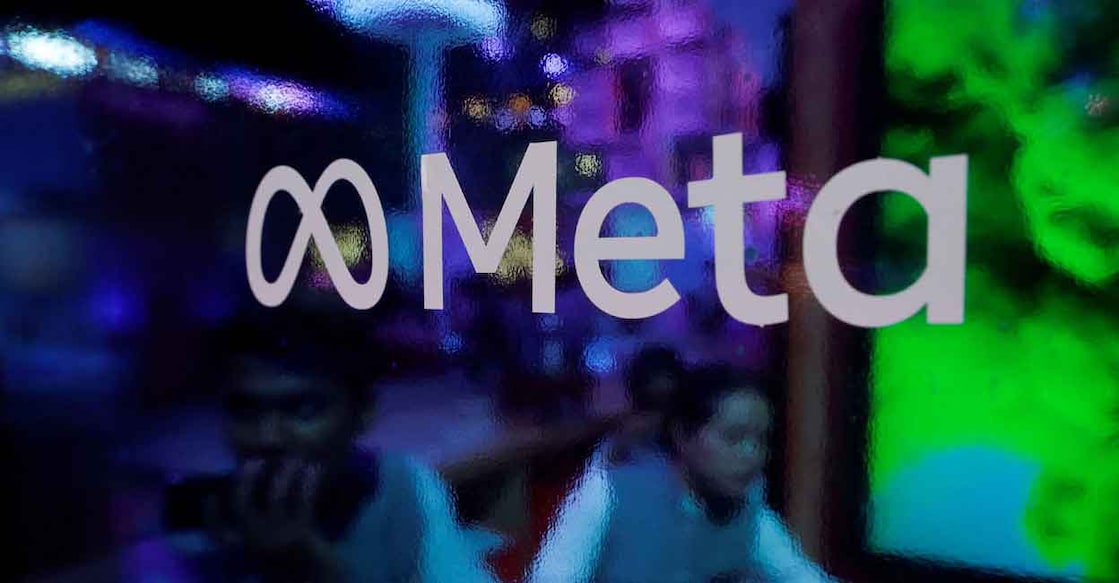 People are seen behind a logo of Meta Platforms, during a conference in Mumbai, India, September 20, 2023. File Photo: REUTERS/Francis Mascarenhas