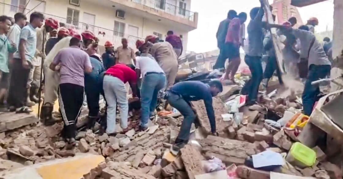 Rescue operation underway after a building collapsed at Satya Niketan area, in New Delhi. Photo: PTI